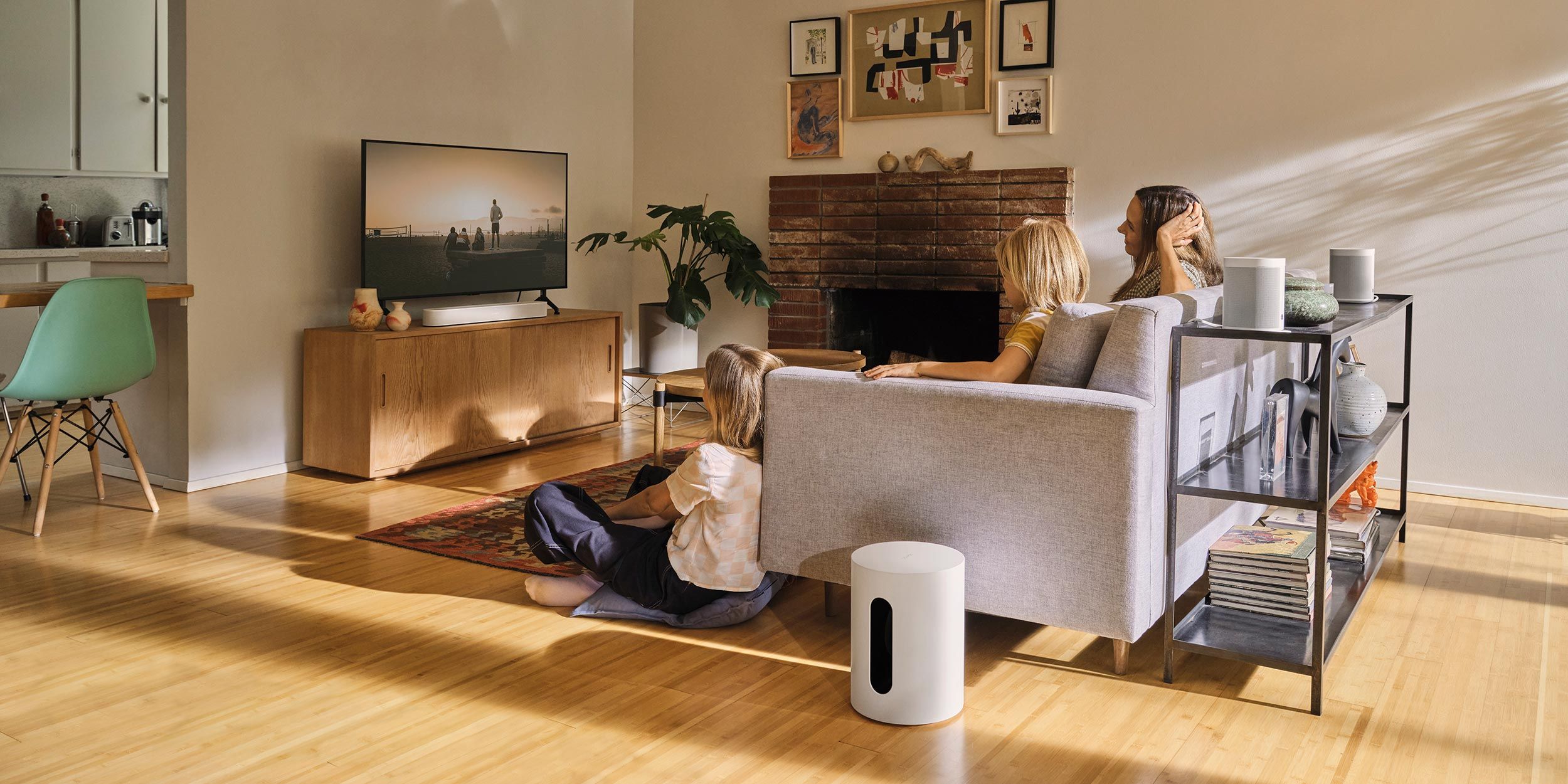 Sonos Ray in a wood and grey living room with two kids and a woman