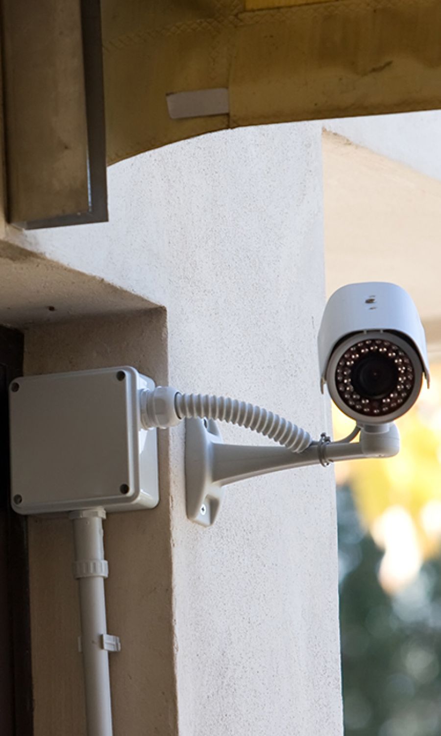 surveillance camera on stucco home